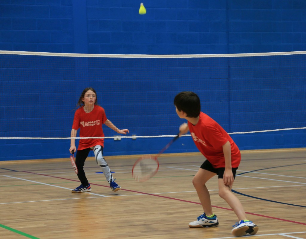 two children playing badminton