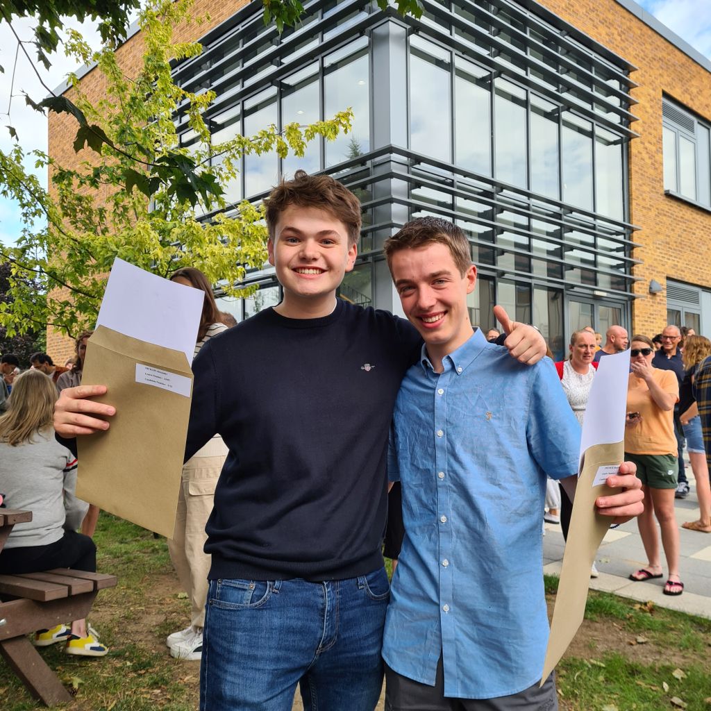 Boys holding exam certificates