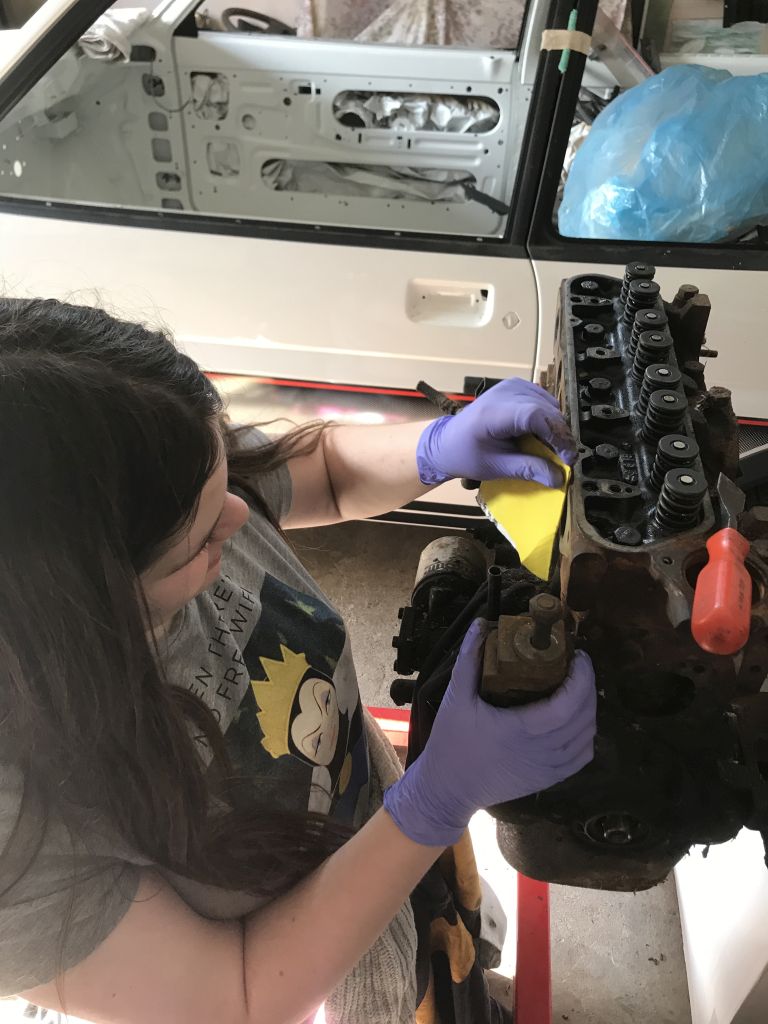 Megan working on her mum's car engine