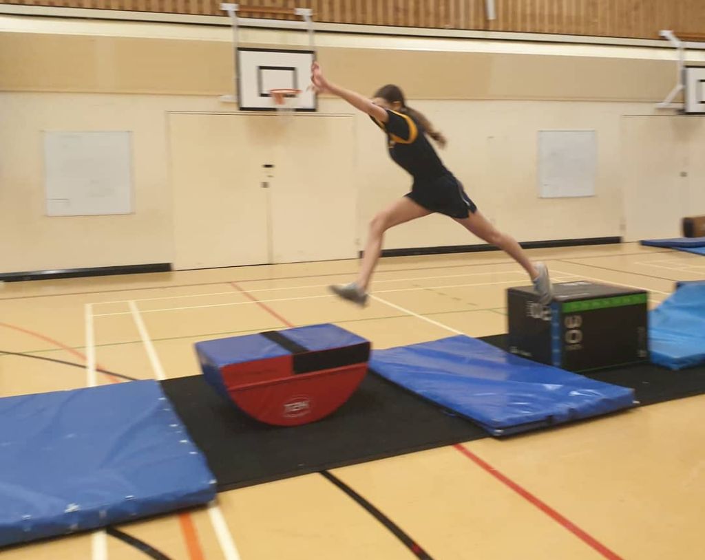 Student jumping across obstacles as part of the Ninja Warrior 2021 competition
