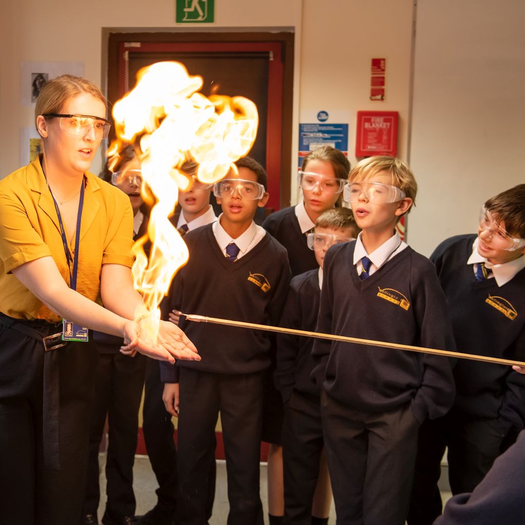 Teacher with flames in hand in a science lesson
