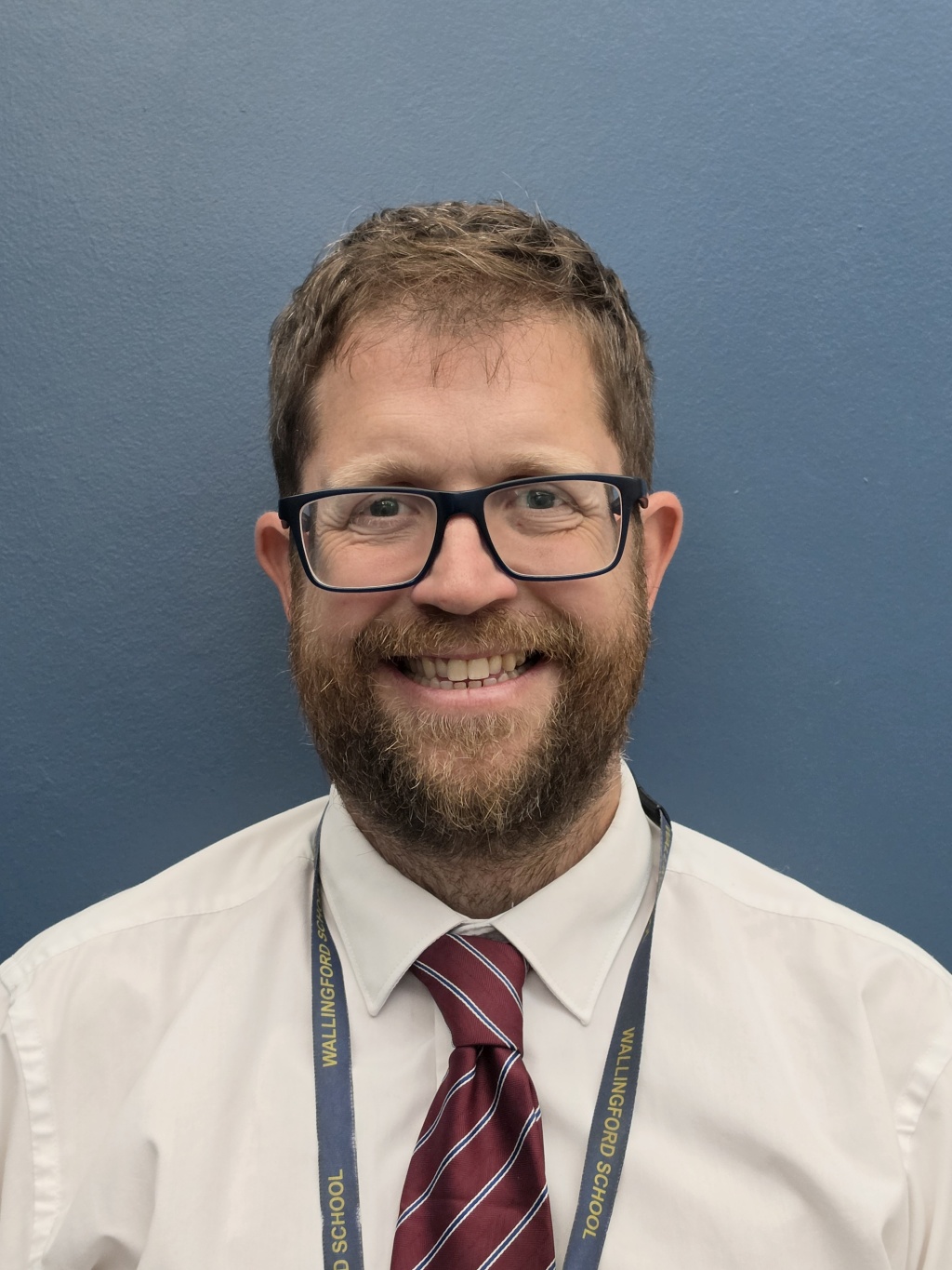 Mr Keeling standing in front of a blue background