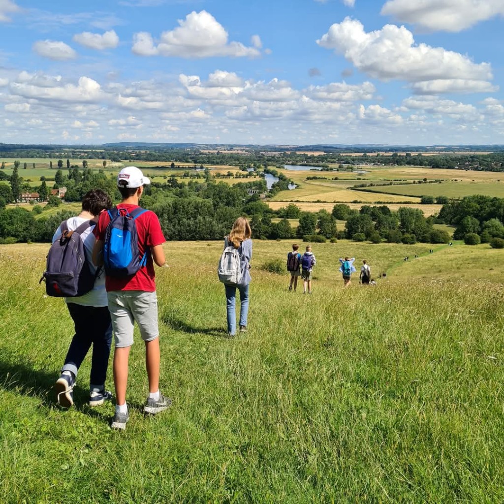 Staff and students walking down a hill during the 2023 sponsored walk